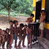 The children are standing in  line to receive flu prevention.