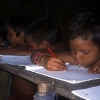 At school, the young Yanomami learn to write and read in their own language.